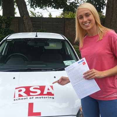 Learner holding her pass certificate, RSA School of Motoring